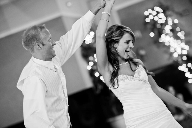staying calm on your wedding day, Bride and Groom having fun and dancing in black and white