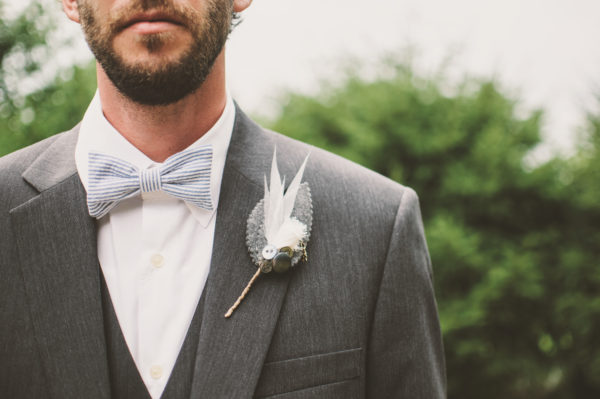 Groom in gray suit with boutonniere